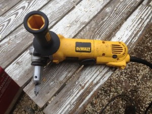 An angle grinder with an adapter and bit for log drilling